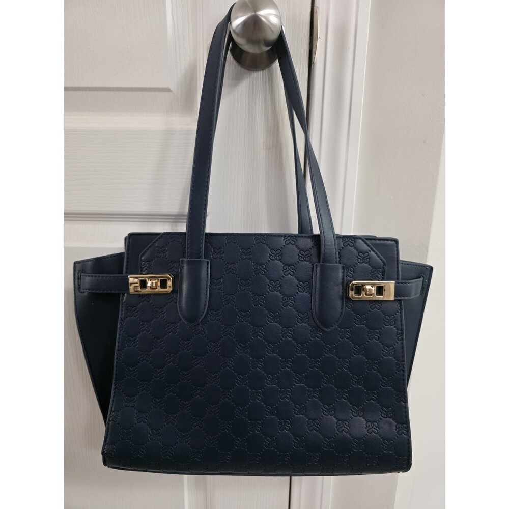 Navy blue faux-leather shoulder bag featuring dual top handles rear zipper